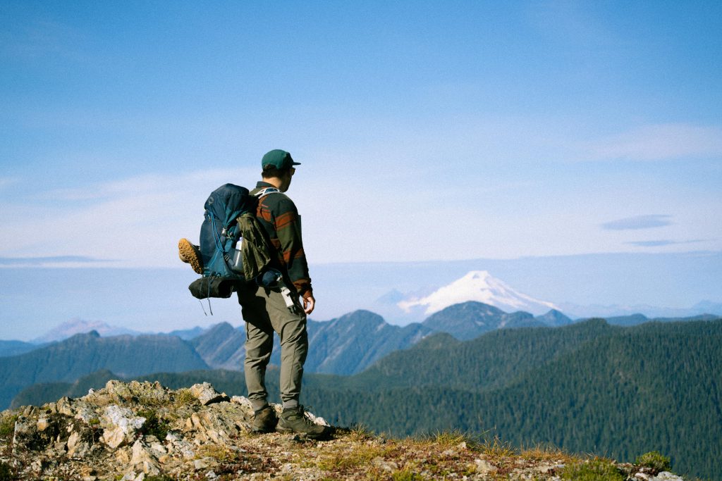 Hiker enjoying a breathtaking view of Mt. Baker in Washington, perfect for travel and adventure themes.